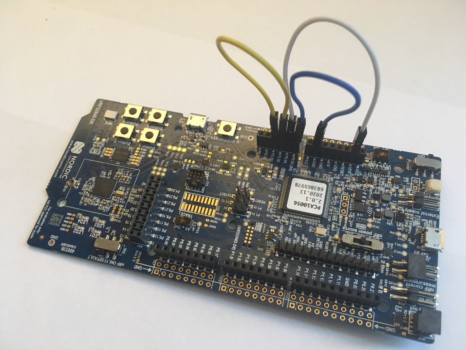Hardware setup for testing the nRF52840 Hardware Abstraction Layer: a nRF52840 DK development board plus 3 wires that connect some pins to each other